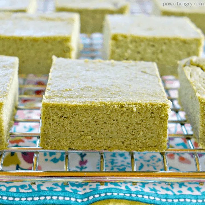 close up of fresh herb lentil bread on a silver cooling rack , with a colorful napkin beneath