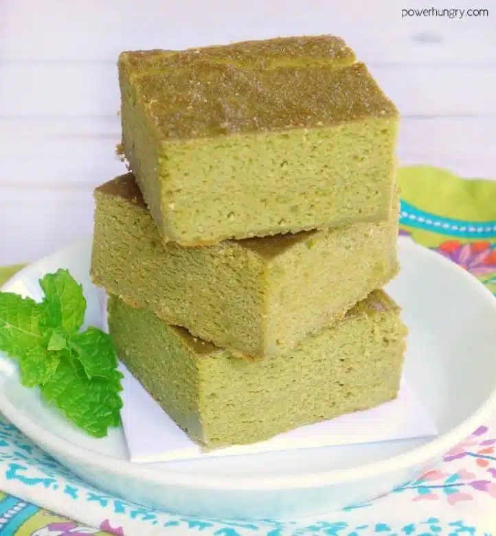 3 stacked squares of fresh herb lentil bread on a white plate