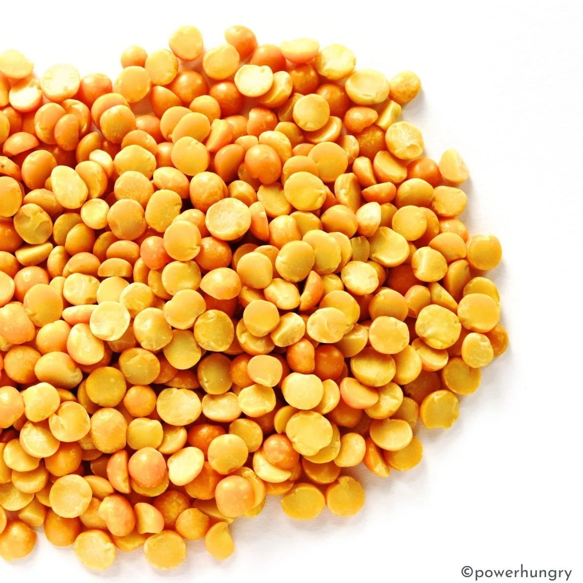 yellow split peas on a white surface