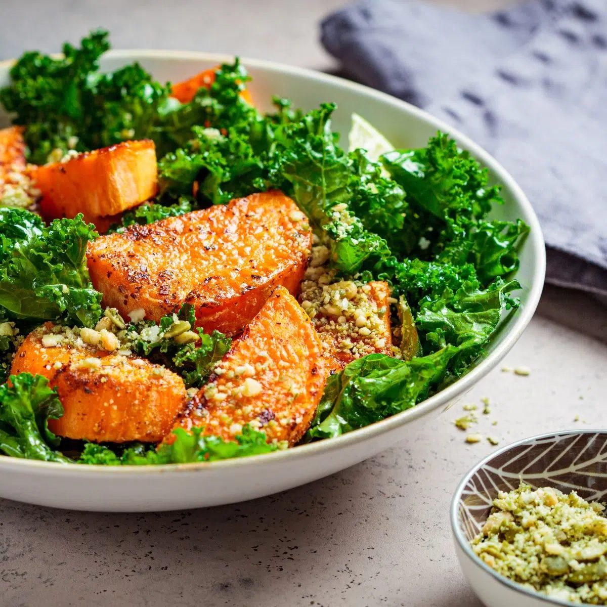 sweet potato kale salad in a white bowl