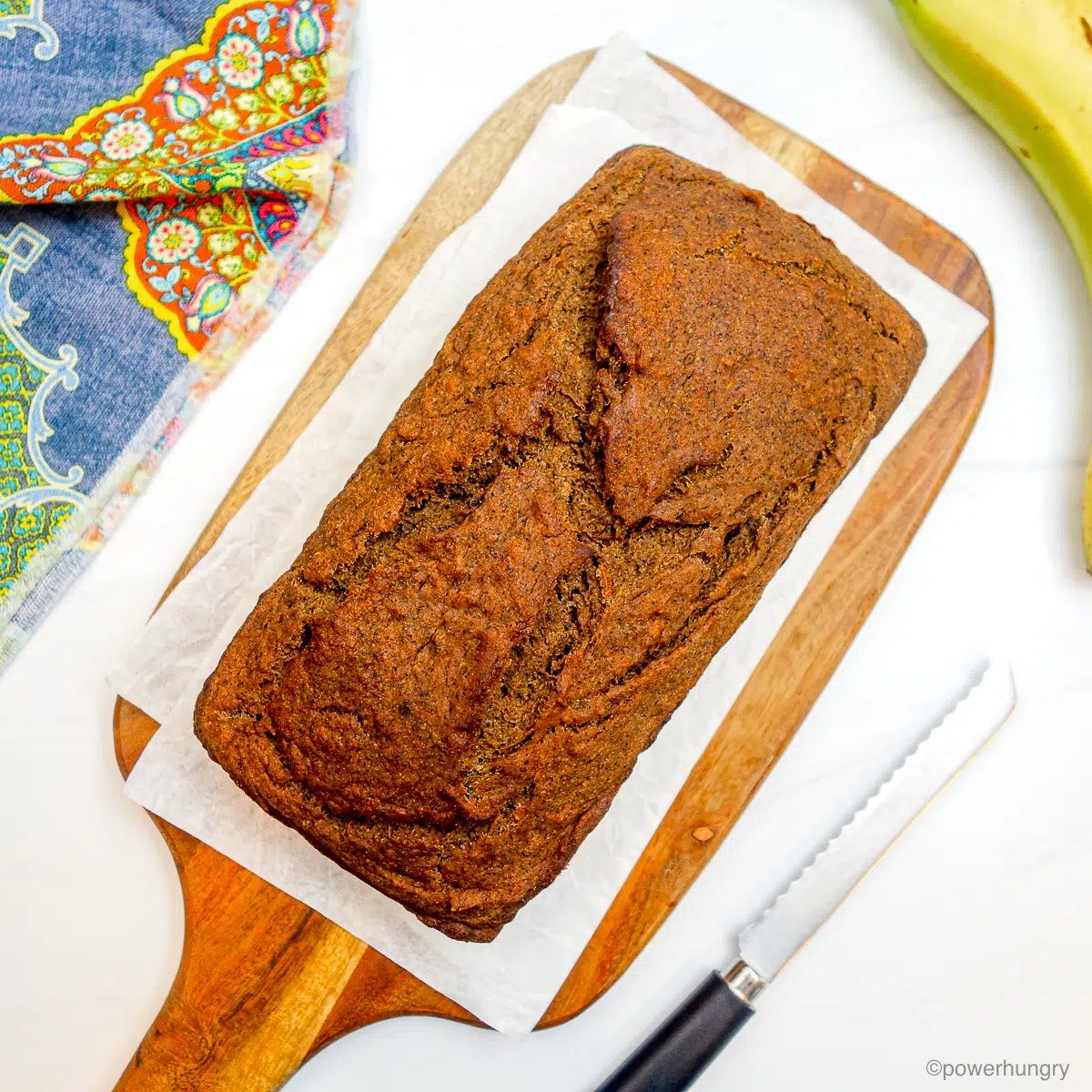 loaf of teff banana bread on a cutting board