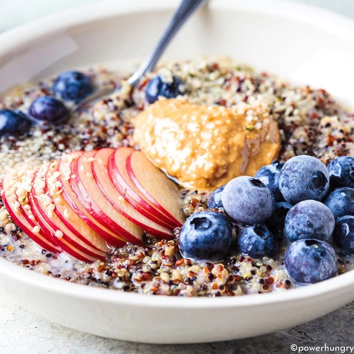 a bowl of quinoa porridge with various toppings