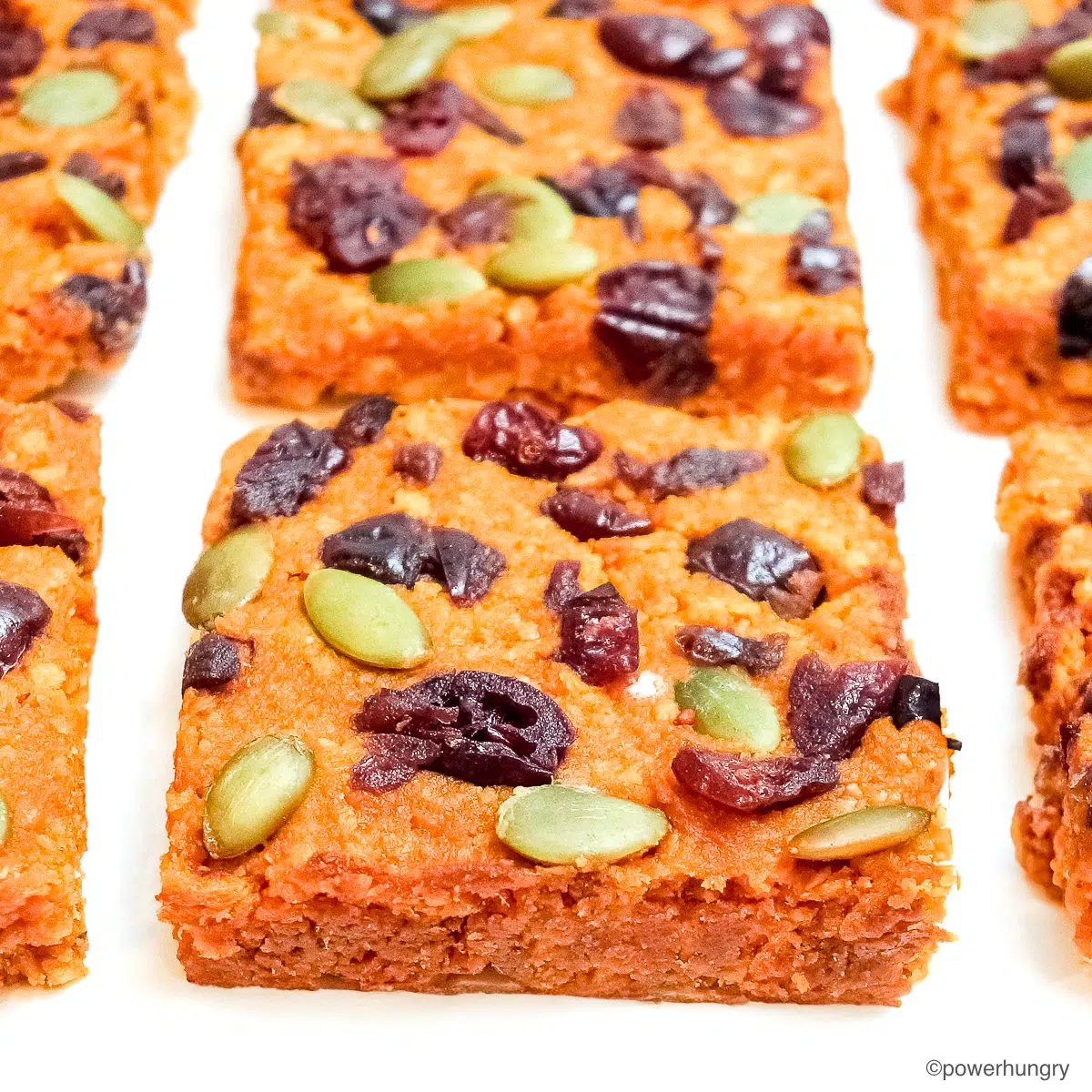 close up of tvp pumpkinprotein bars on a piece of white parchment paper