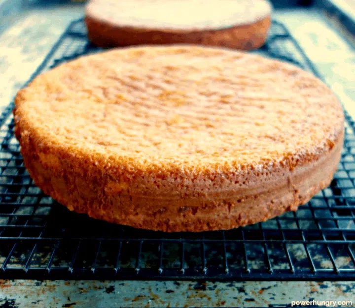 grain-free and vegan vanilla cakes layers on a black cooling rack