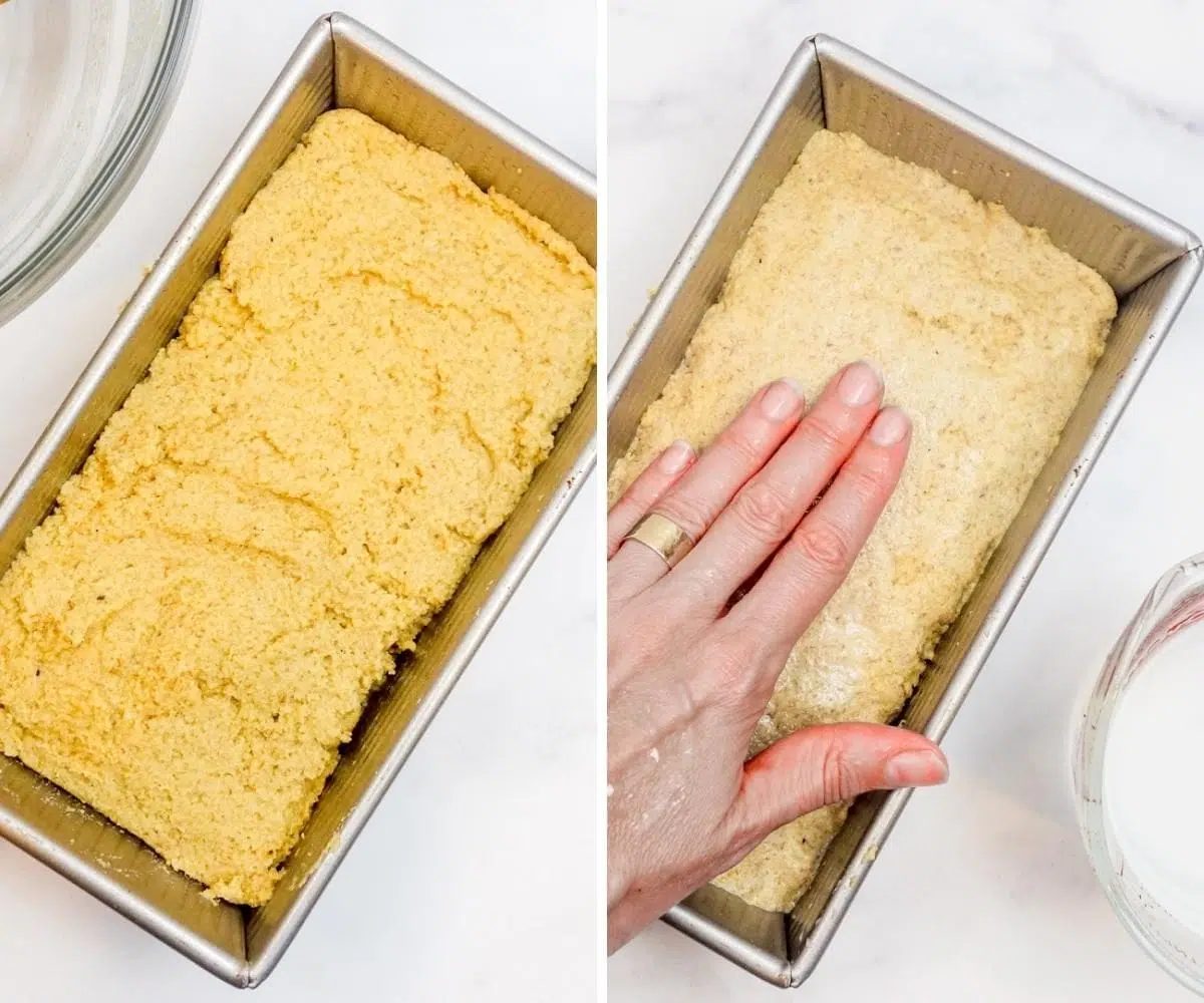 bread dough in a silver pan, being smoothed out