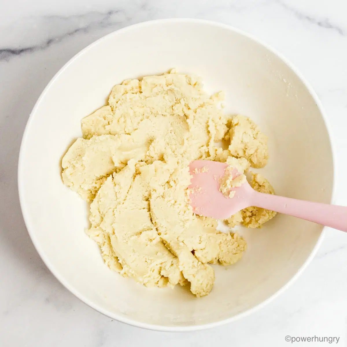 white bowl filled with almond flour sugar cookie dough