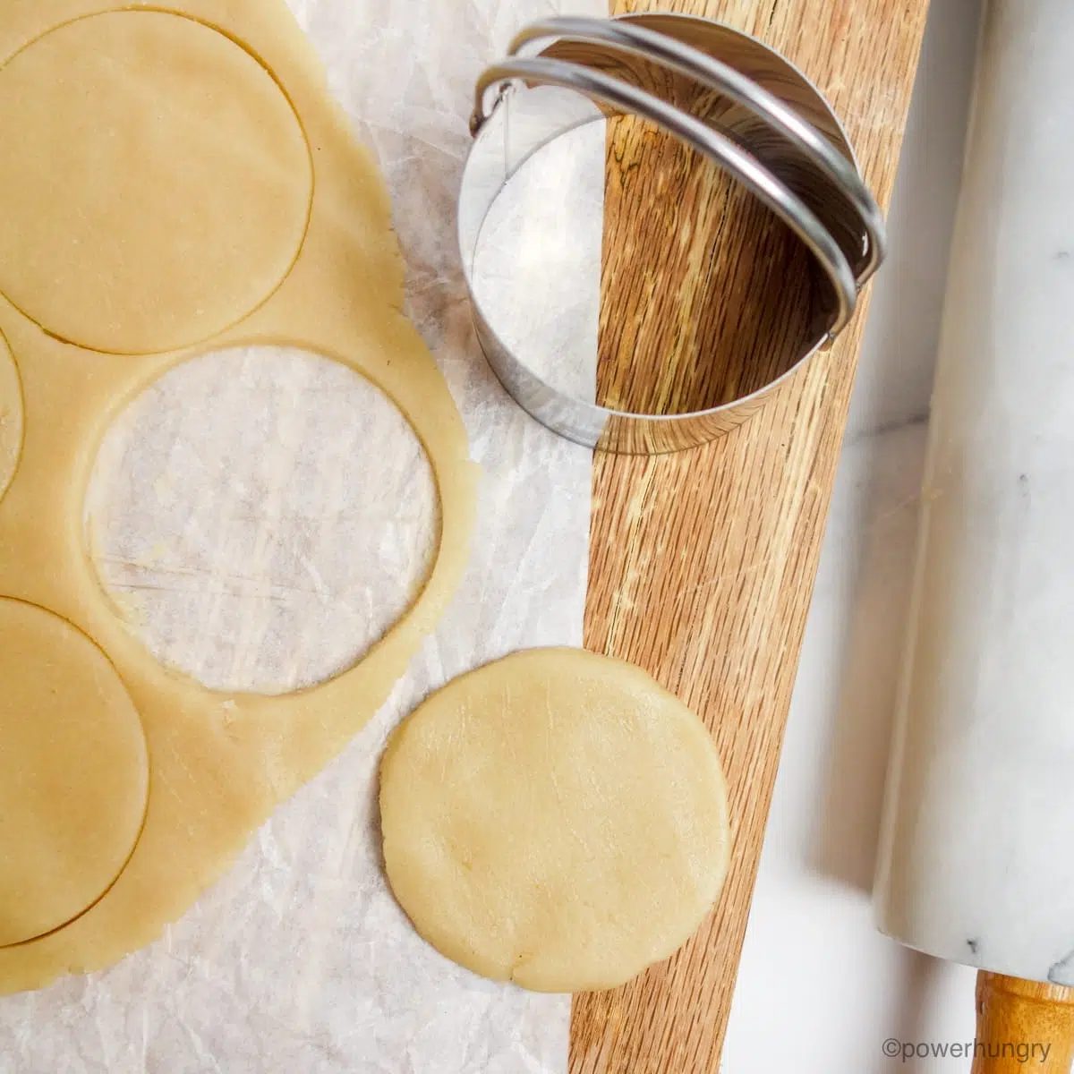 vegan sugar cookie dough, rolled out, and cut out with a round cookie cutter