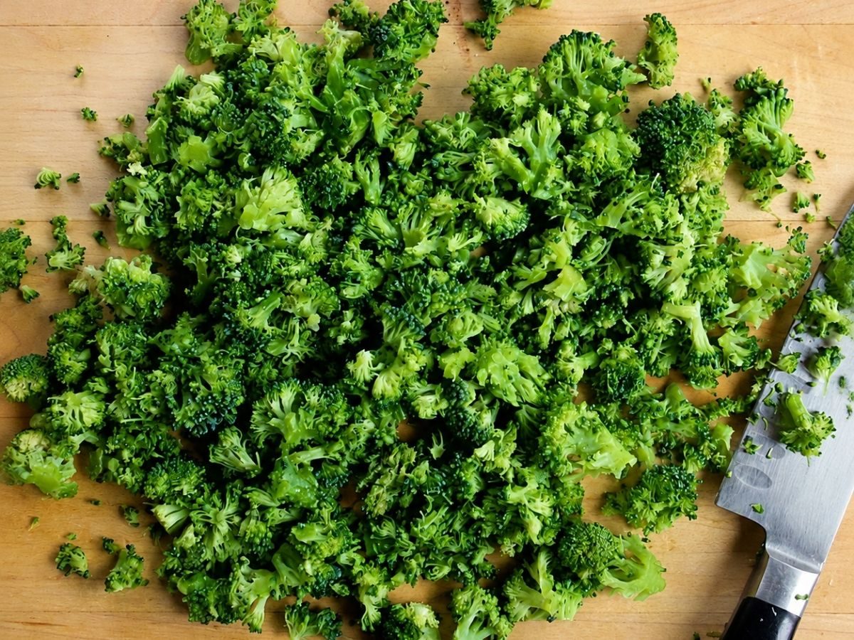 chopped broccoli on a wood cutting board