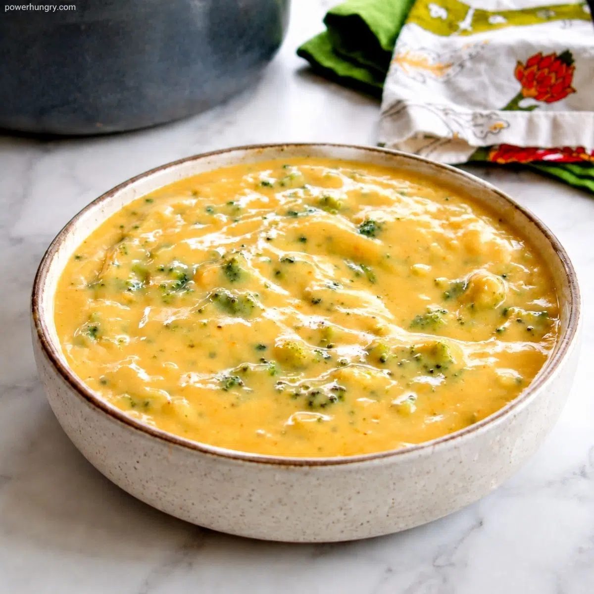 vegan broccoli cheese soup in a brown stoneware bowl