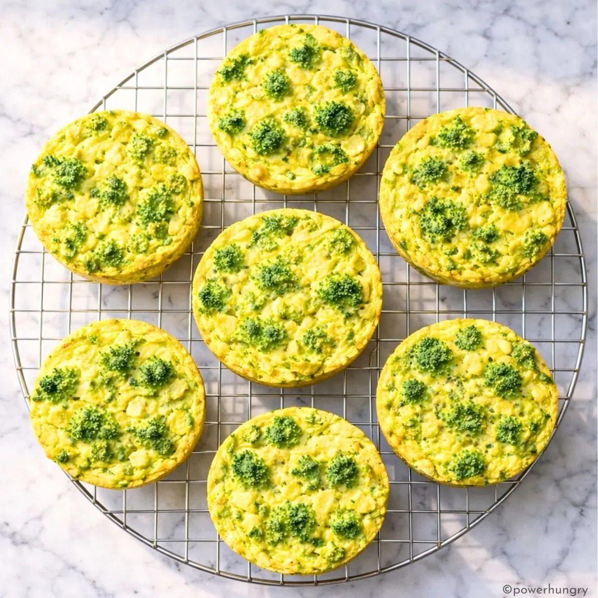 vegan broccoli rice casserole muffins , shot from overhead, on a cooling rack