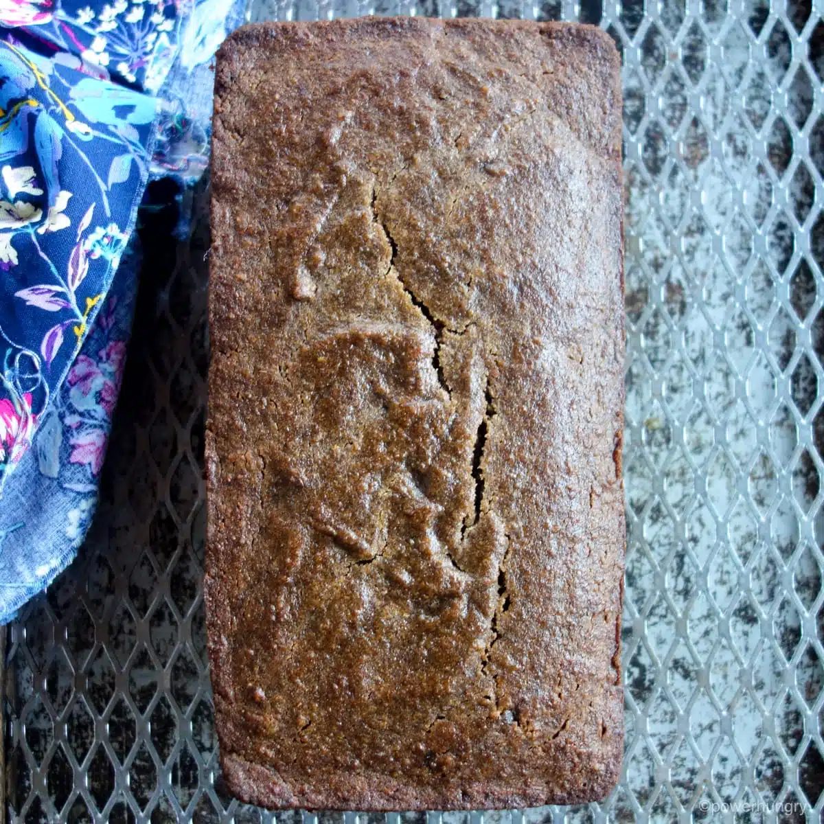 loaf of buckwheat banana bread on a cooling rack