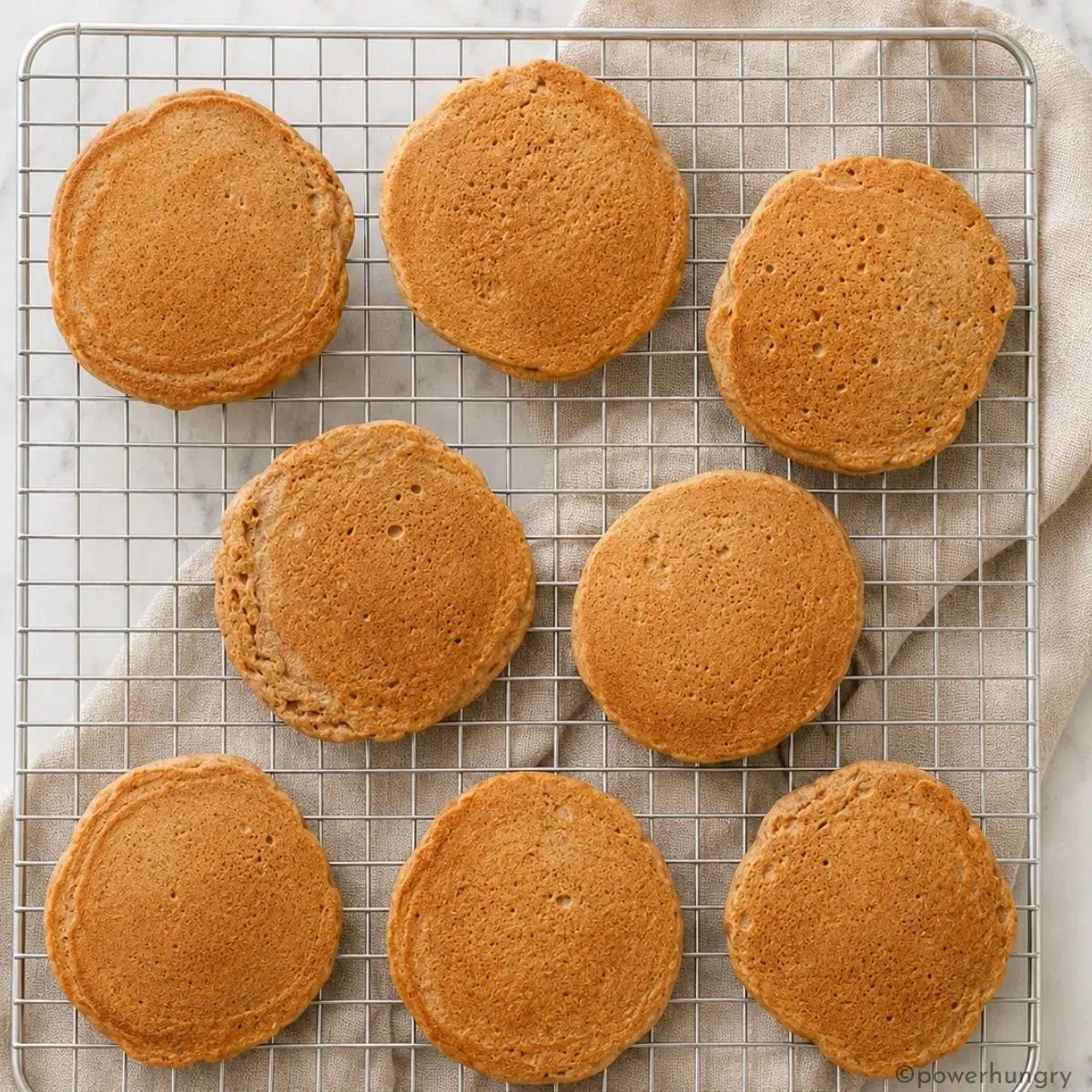 eight vegan buckwheat pancakes on a silver cooling rack