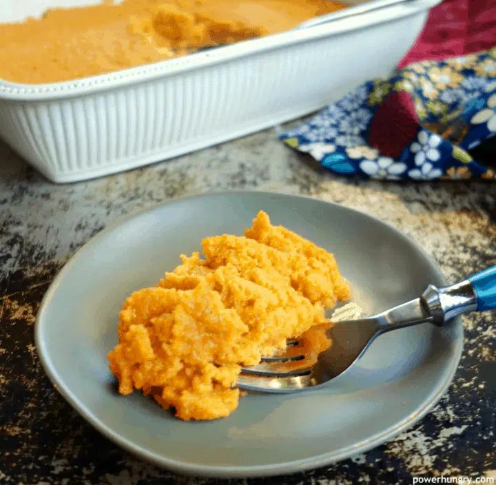 A serving of vegan carrot soufflé on a gray plate