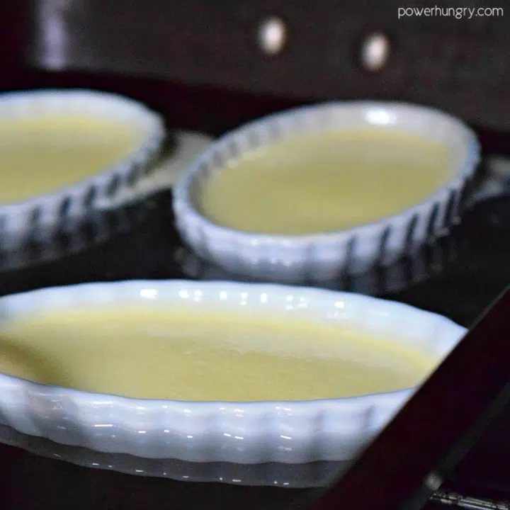 creme brulee in a hot water batch, about to be baked in the oven.