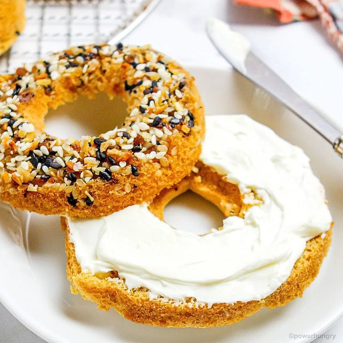 split chickpea flour vegan bagel with vegan cream cheese spread on it