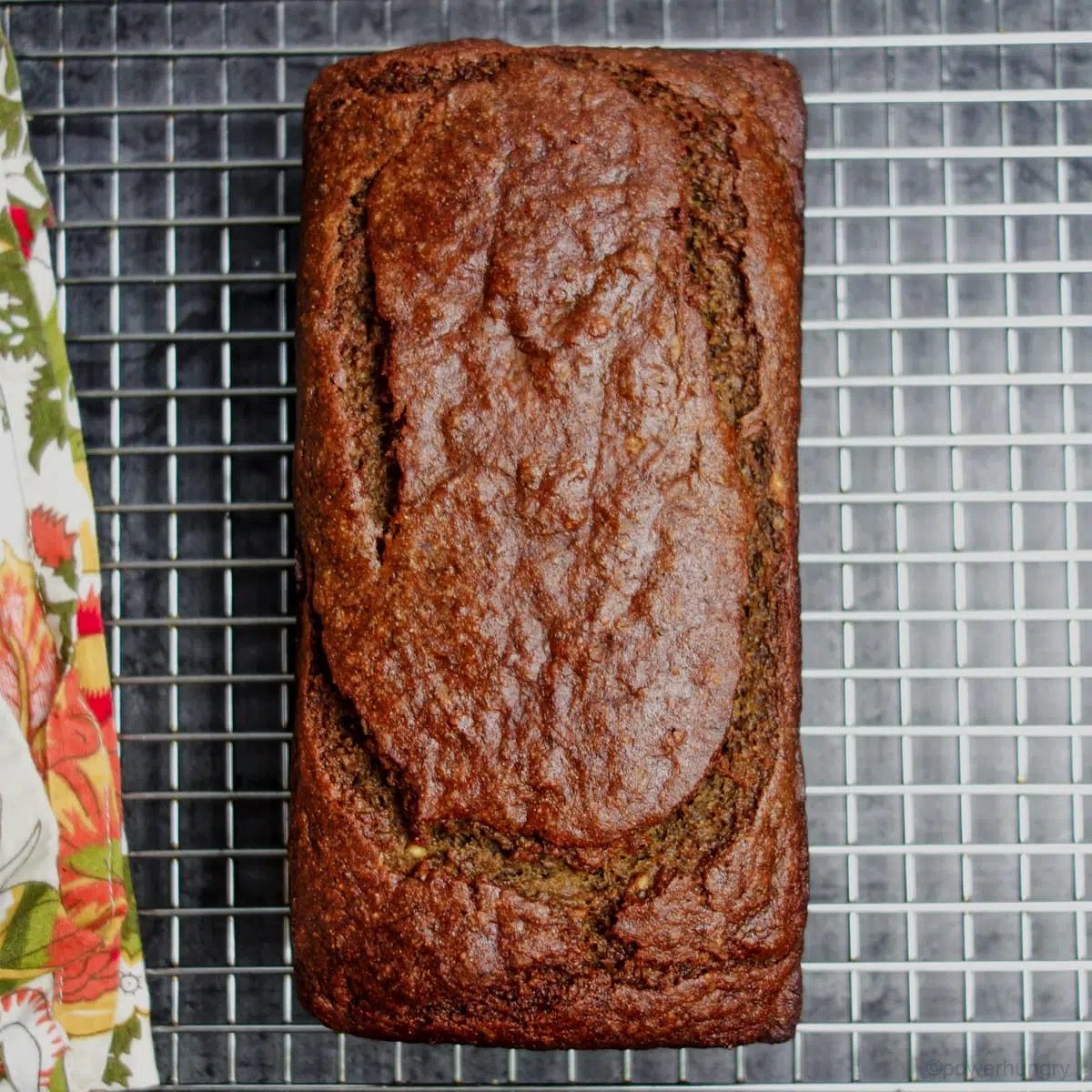 loaf of vegan banana bread cooling on a wire cooling rack