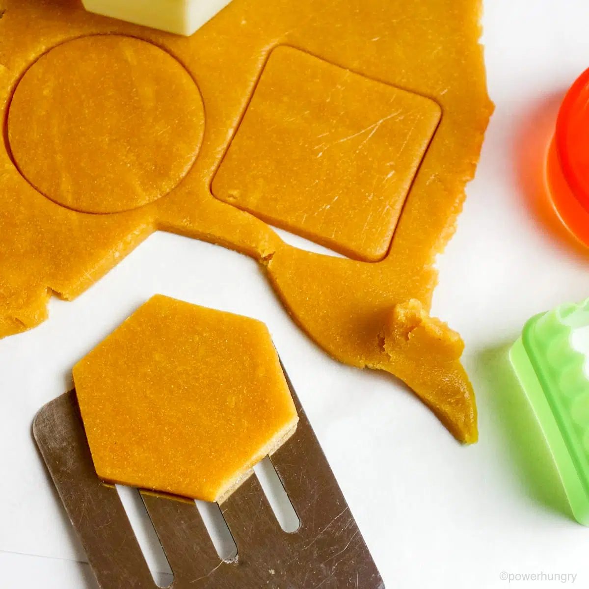 cookie shapes being transferred with a metal spatula