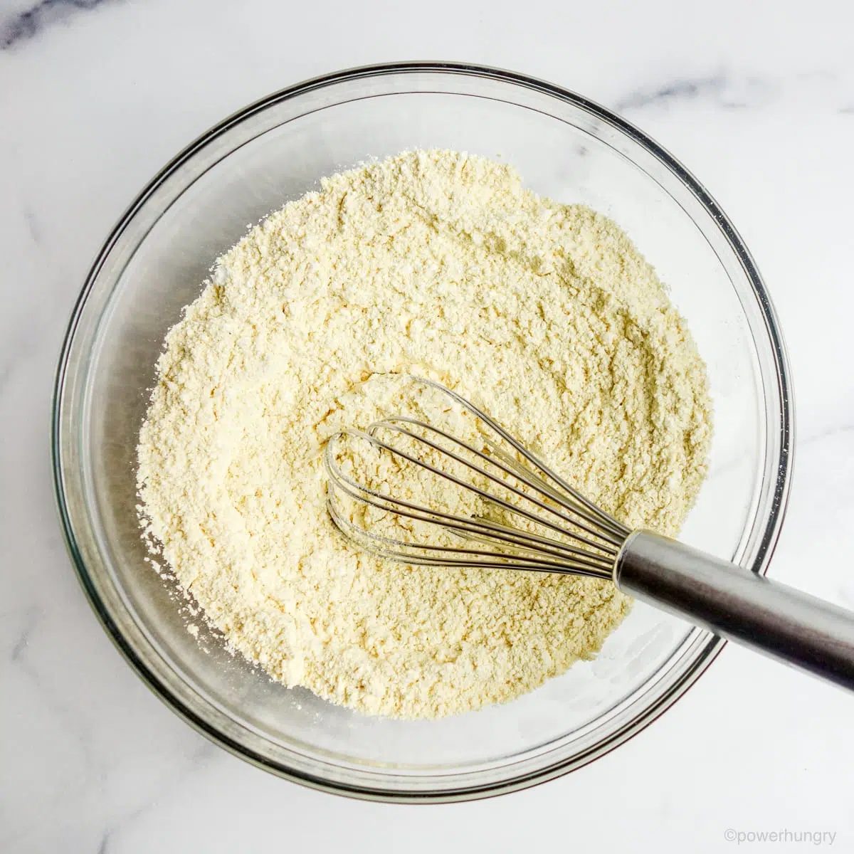 whisked chickpea flour and powdered sugar in a glass bowl