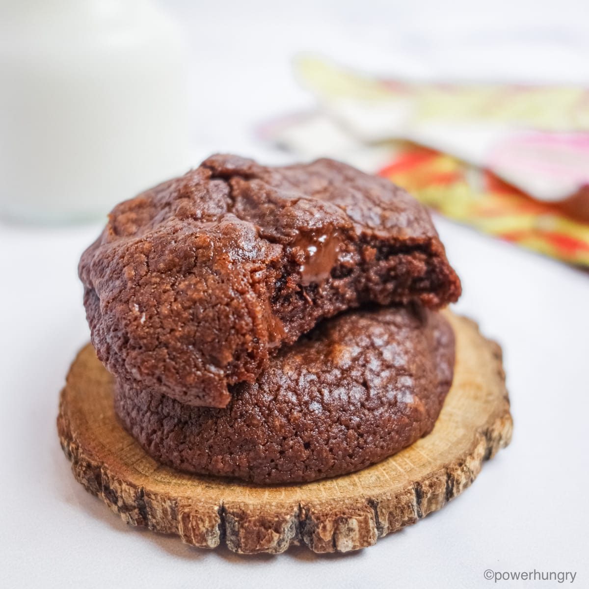 two chocolate avocado cookies stacked on top of each other