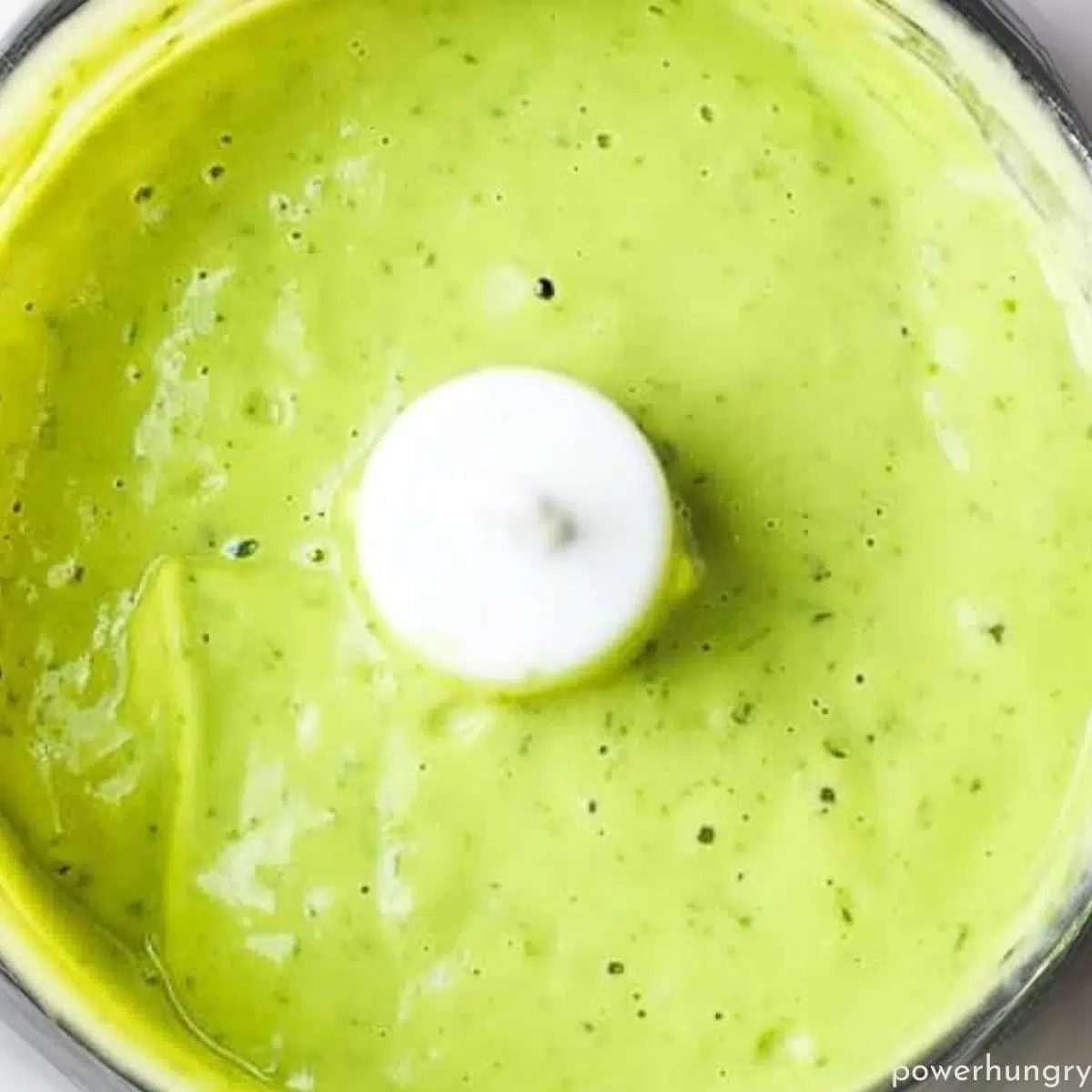 overhead shot of avocado and water puree in a food processor