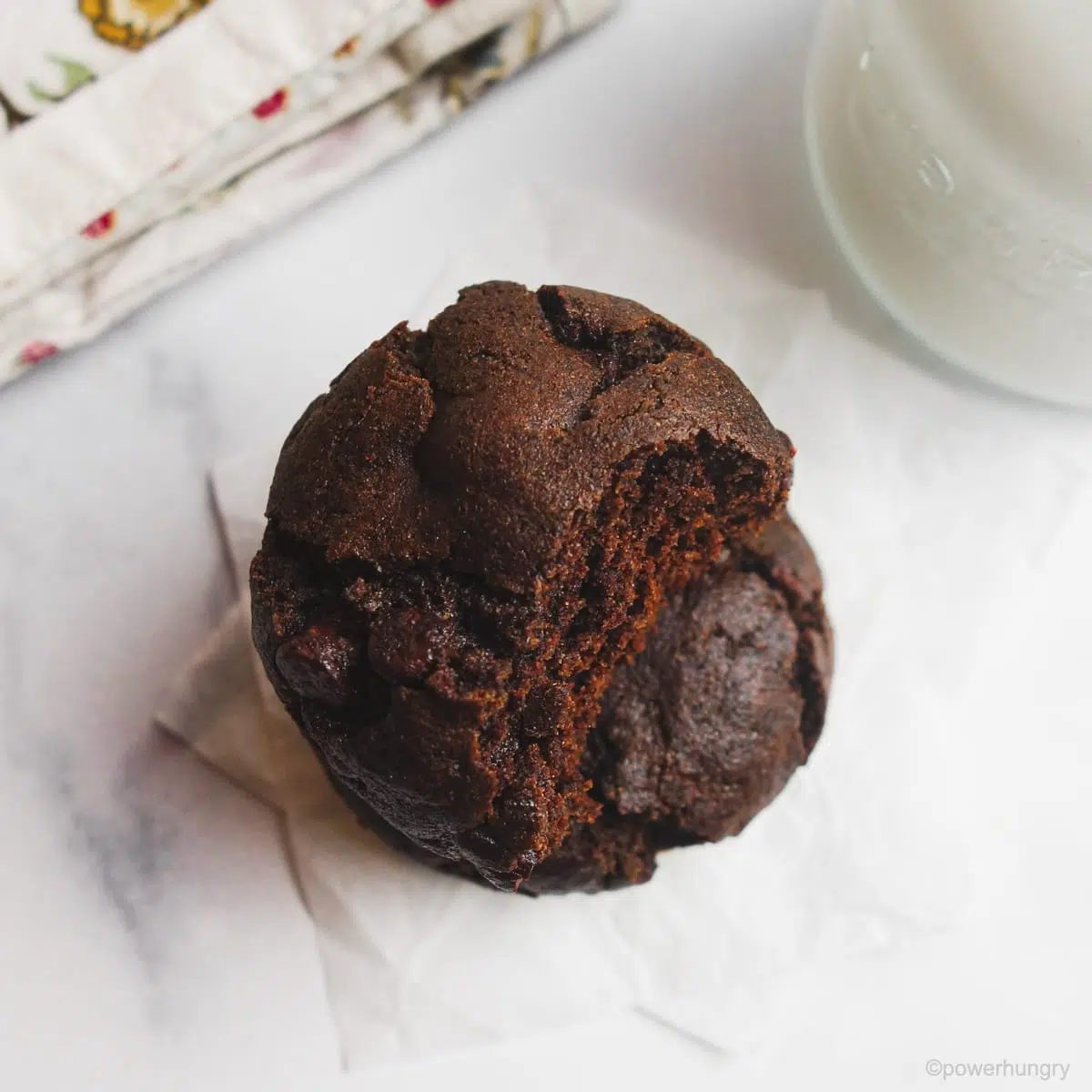 a stack of two chocolate buckwheat cookies. The top one has a bite taken out.