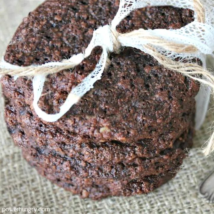 stack of double chocolate oat cookies that are vegan and gluten-free on a piece of brown burlap