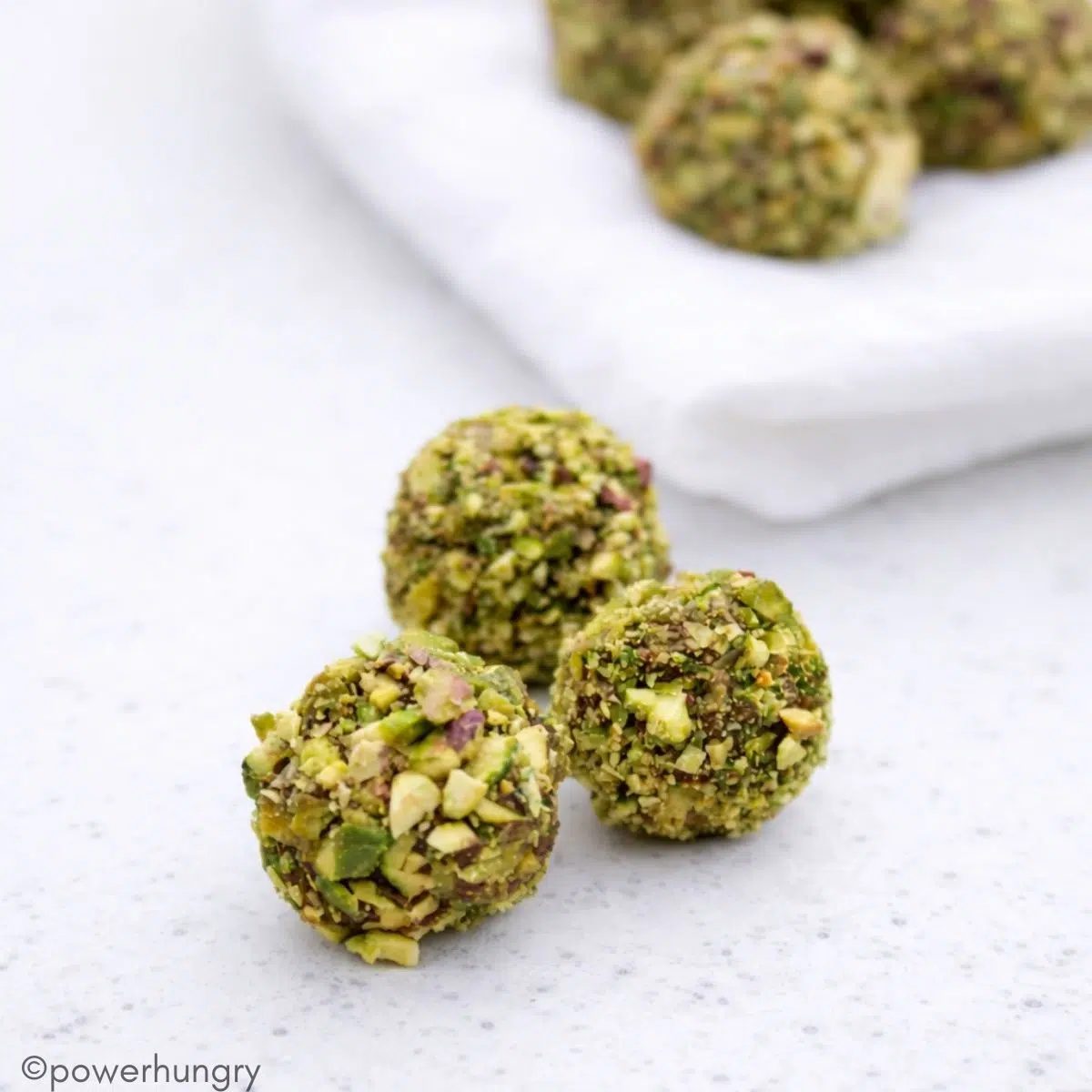 chocolate pumpkin protein balls on a small plate