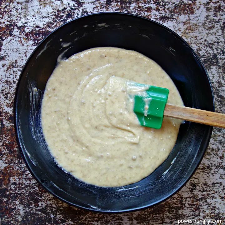 black pottery bowl filled with cake batter