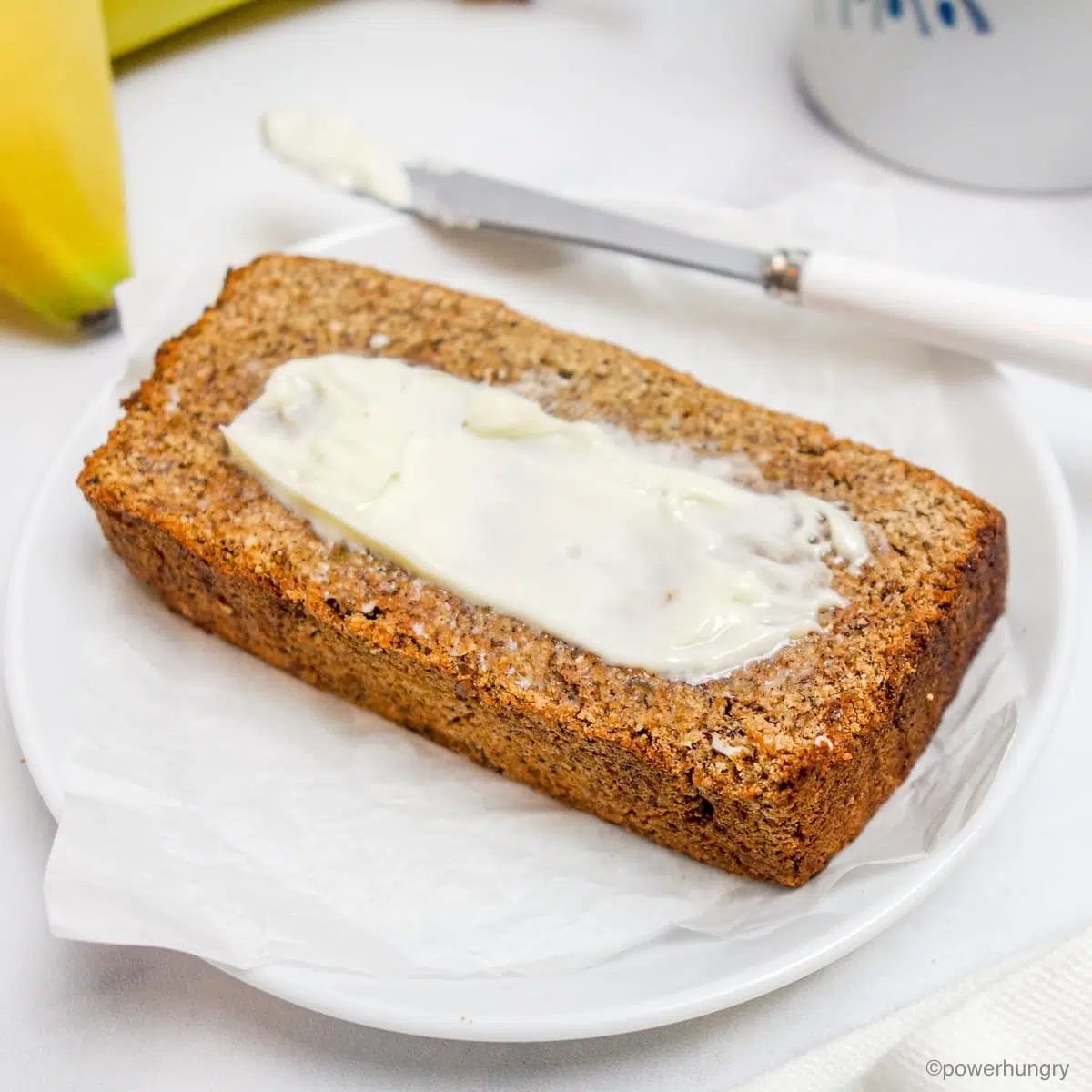 a slice of coconut flour banana bread on a white plate