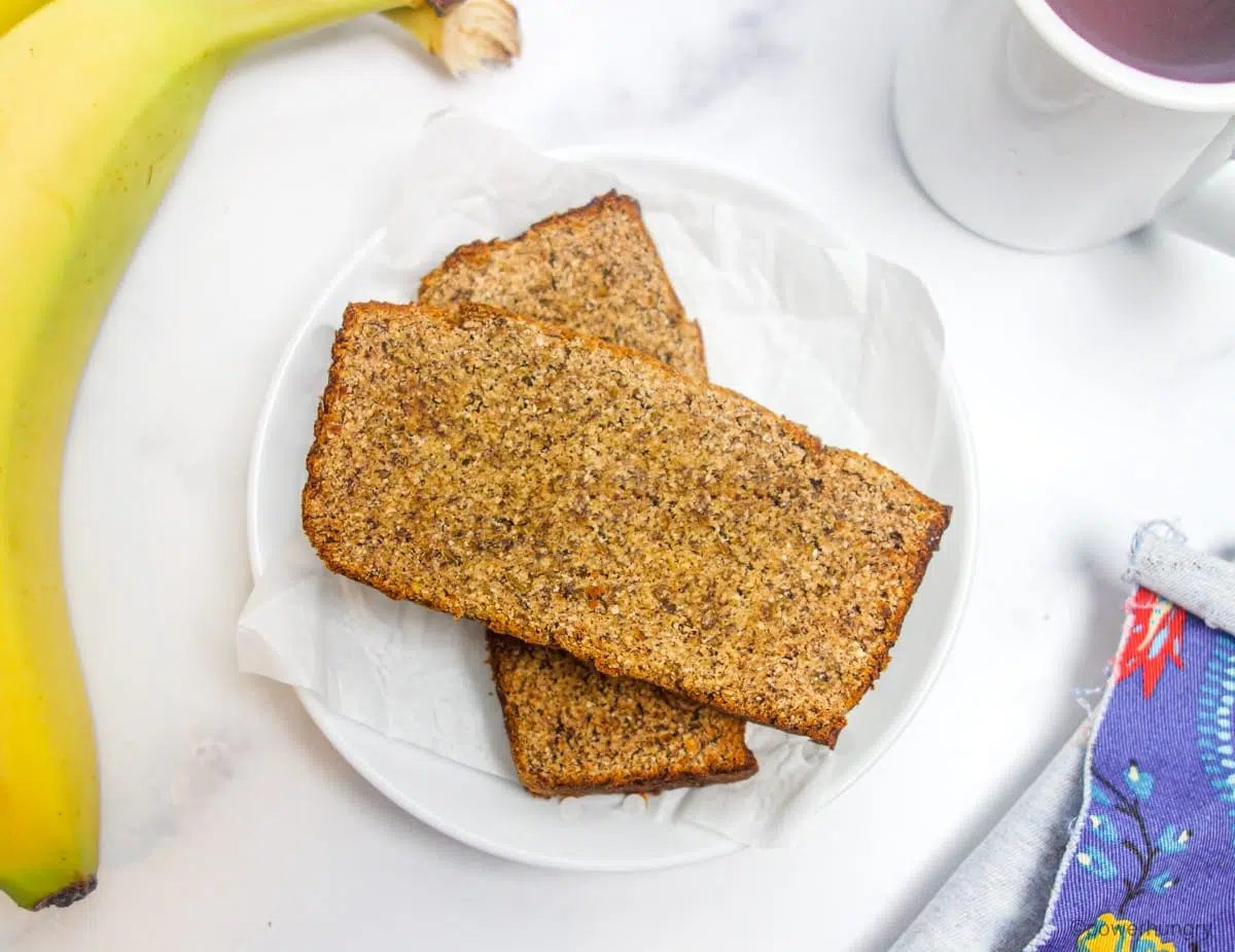 two slices of vegan coconut flour banana bread on a white plate