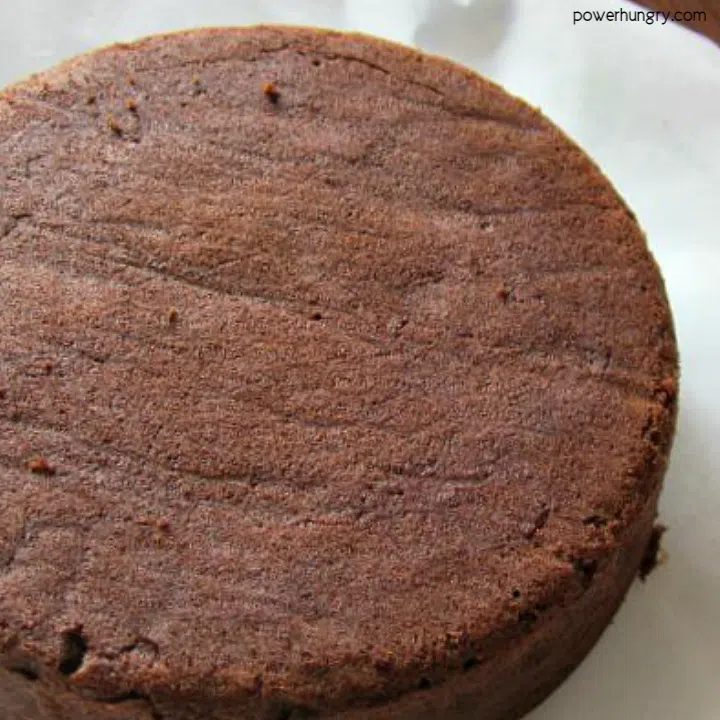 inverted chocolate coconut flour cake on a cooling rack