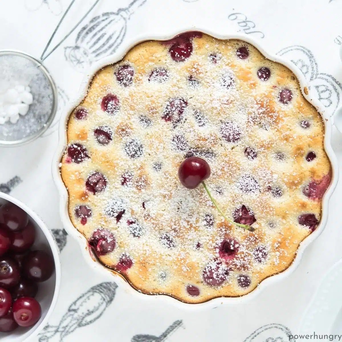 cherry clafouti on a white and gray tablespoon