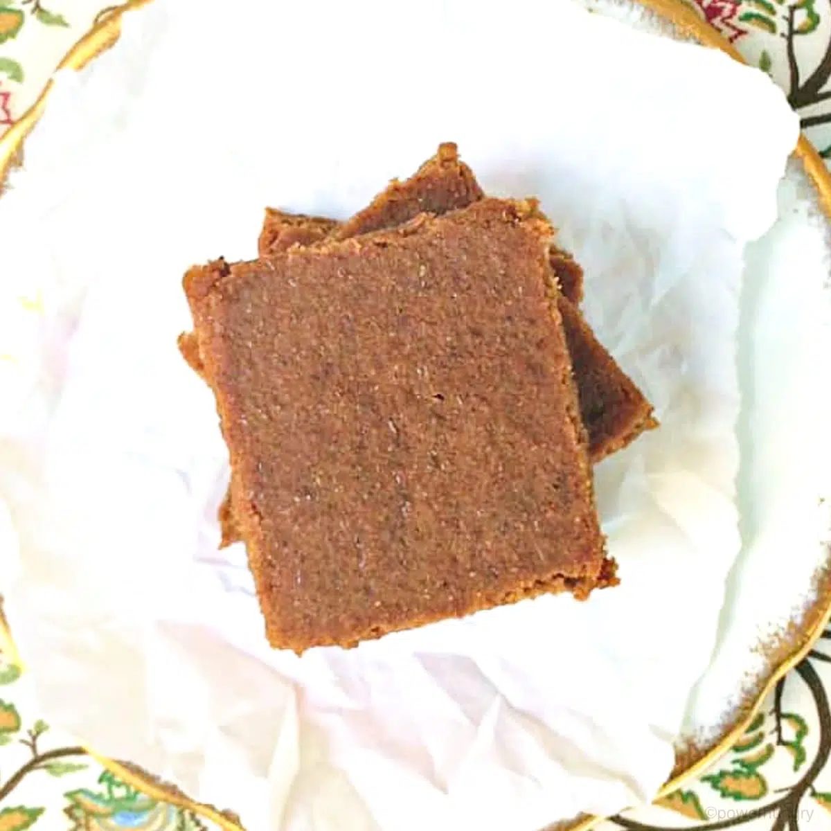 overhead shot of coconut flour blondies on white parchment paper