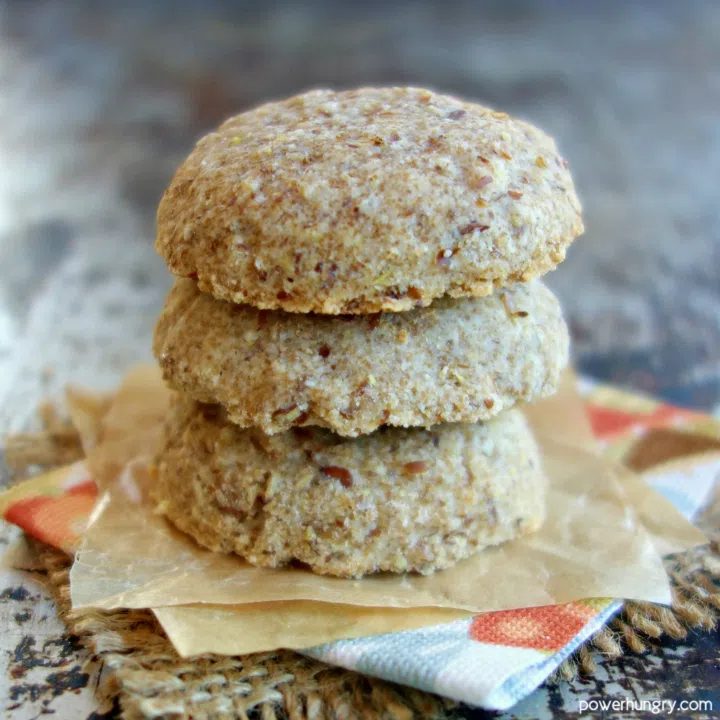 stack of 3 vegan coconut flour sandies on a colorful napkin