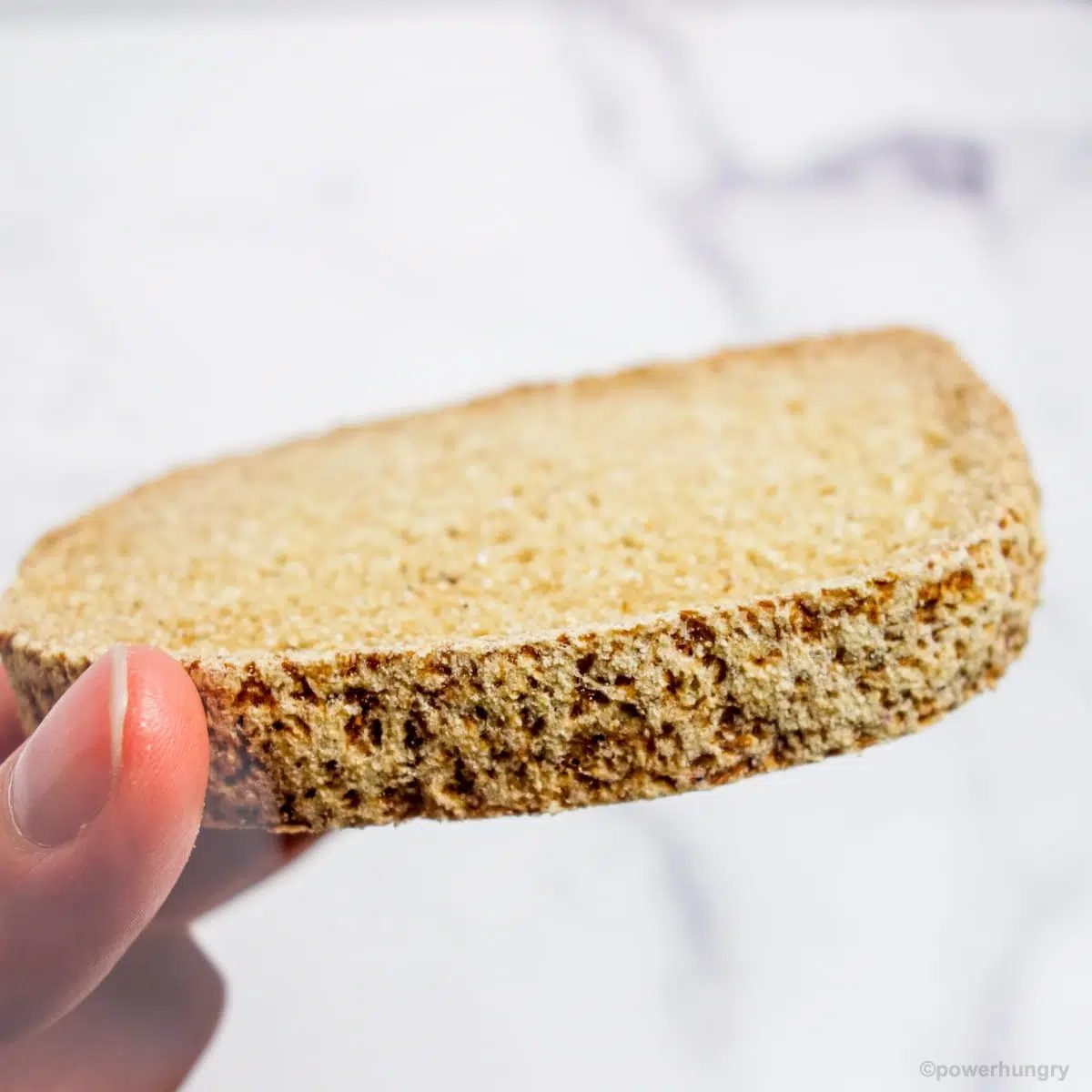 hand holding a piece of bread