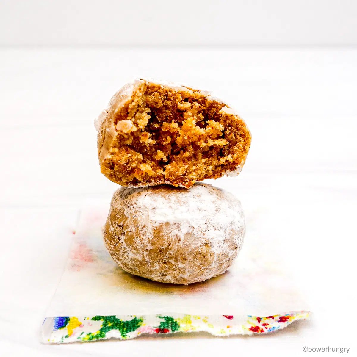 two wedding cookies stacked on top of each other