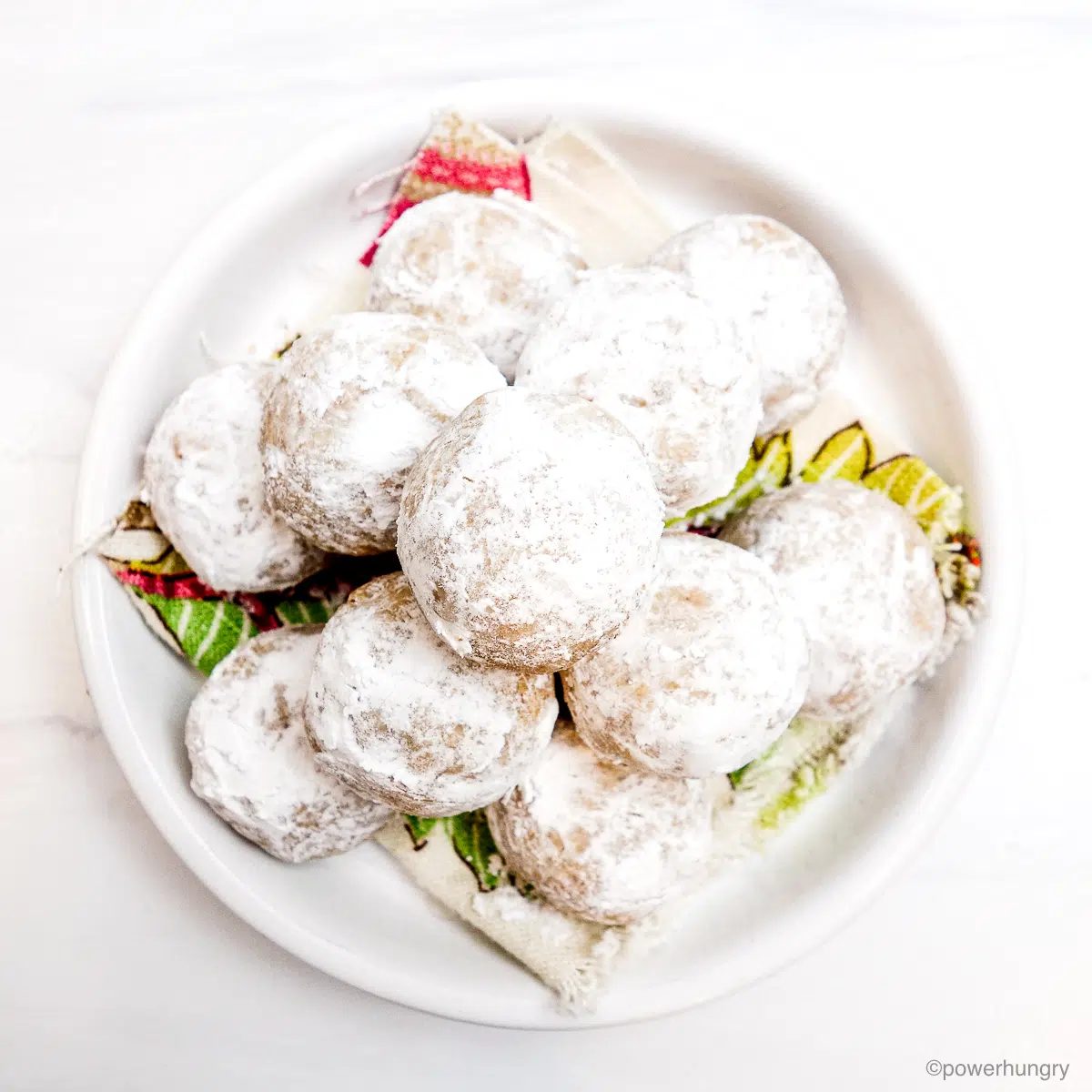 white plate piled with vegan wedding cookies