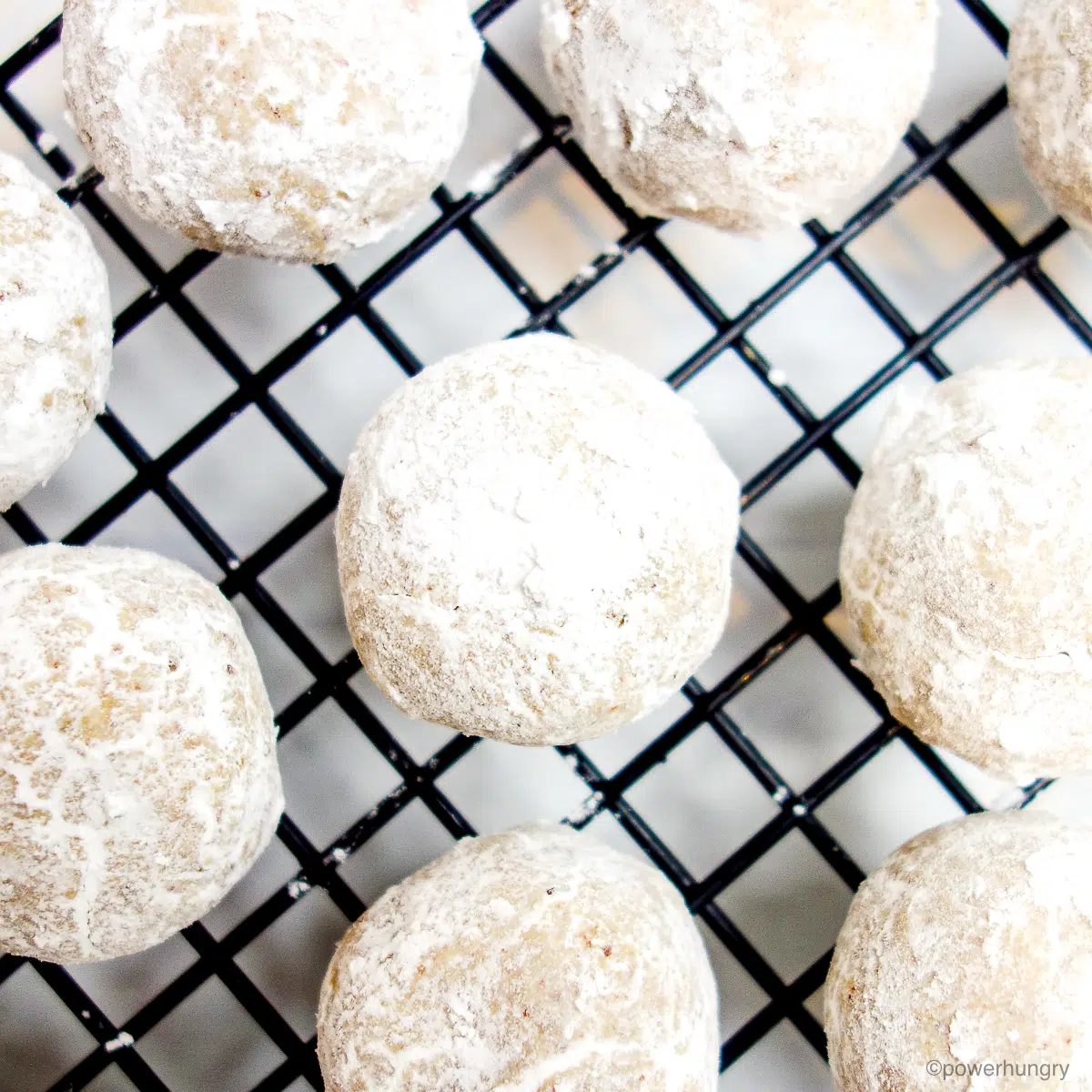 coconut flour wedding cookies on black cooling rack