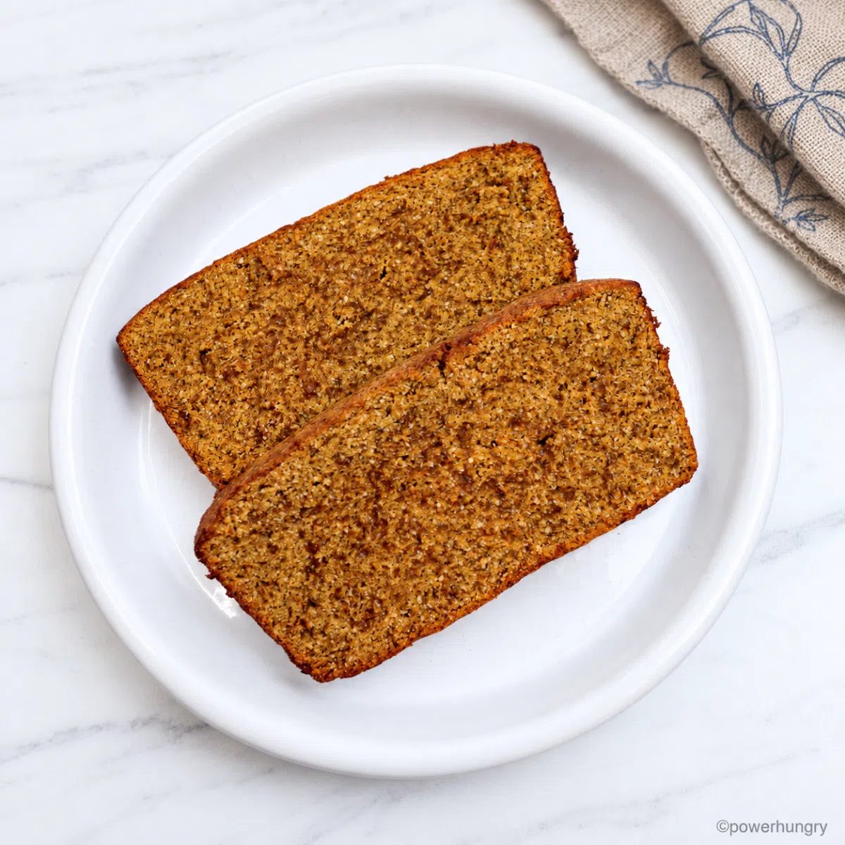 toasted vegan coconut flour pumpkin bread slices on a white plate