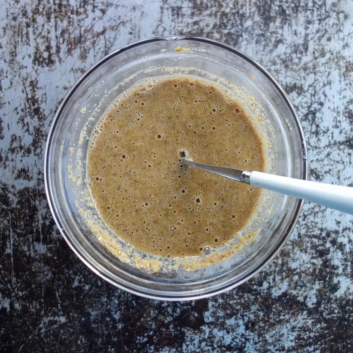 batter for flax muffin shown in a glass bowl