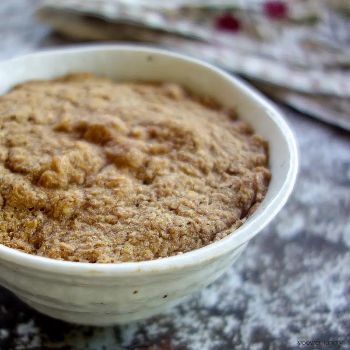 close up of a flax muffin in a natural white bowl
