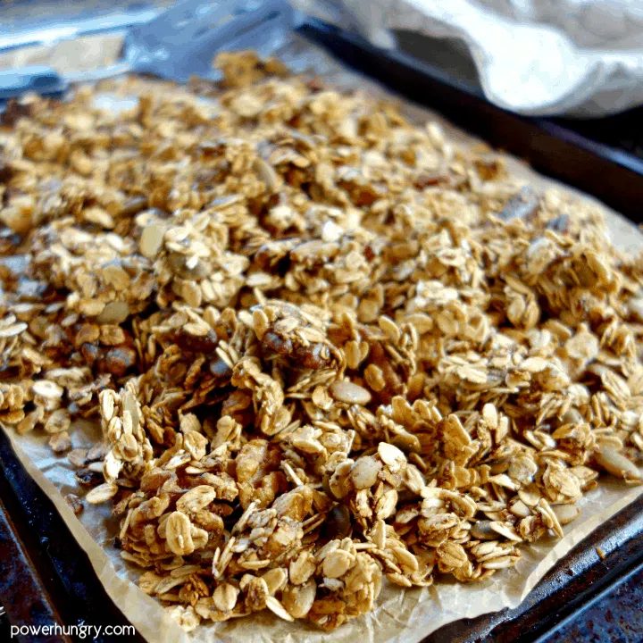 baked nourishing oil-free granola on a parchment paper lined baking sheet