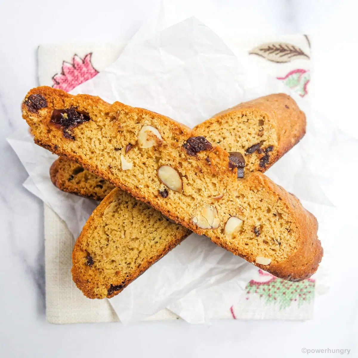vegan gluten free biscotti stacked on a floral napkin