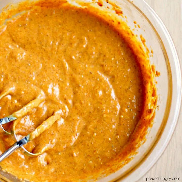 large glass bowl filled with pumpkin bread batter (just the wet ingredients)