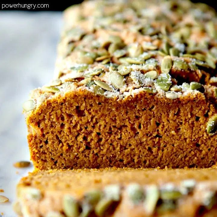 Sliced vegan pumpkin bread on a cutting board