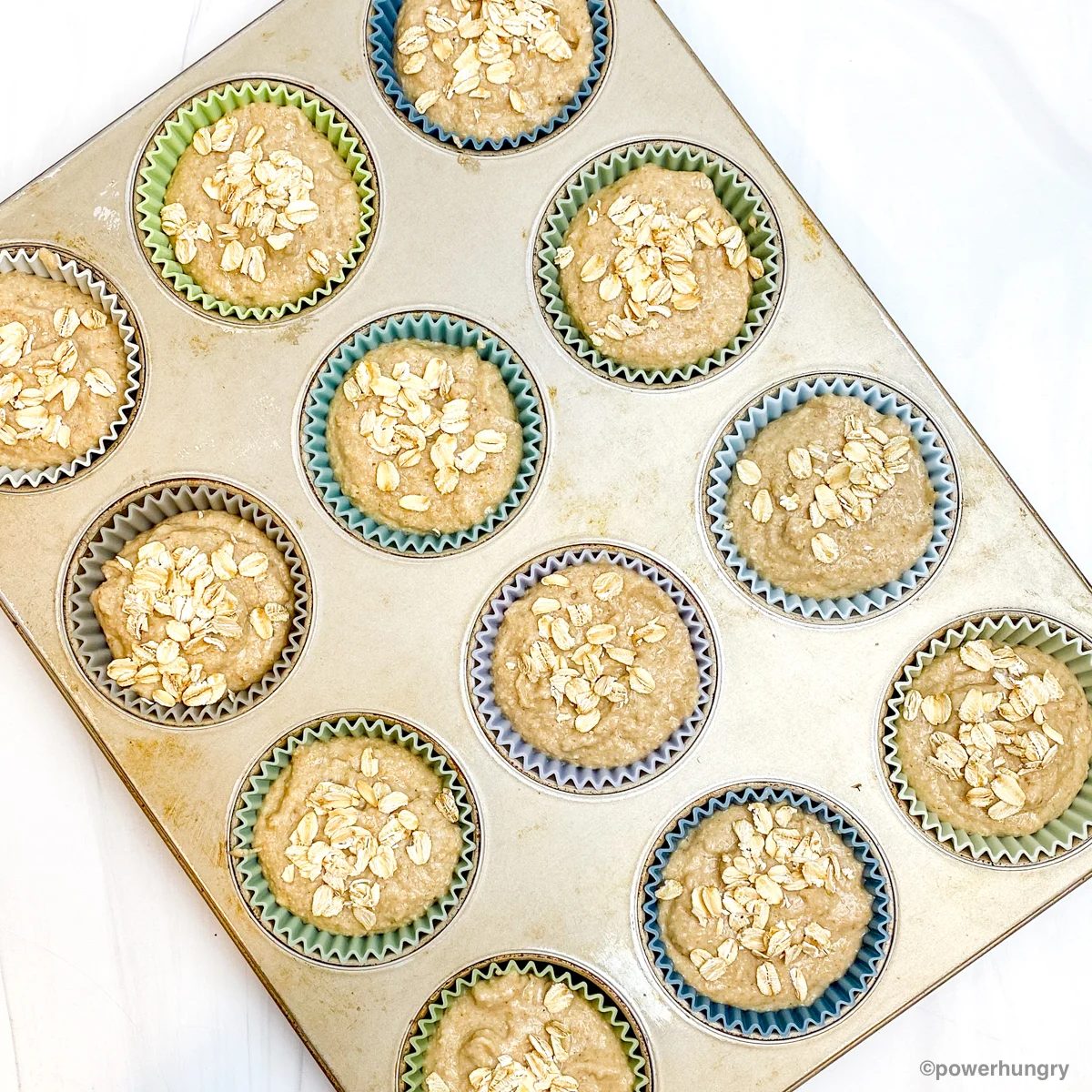 batter for 3 ingredient banana oat muffins in a muffin tin before baking