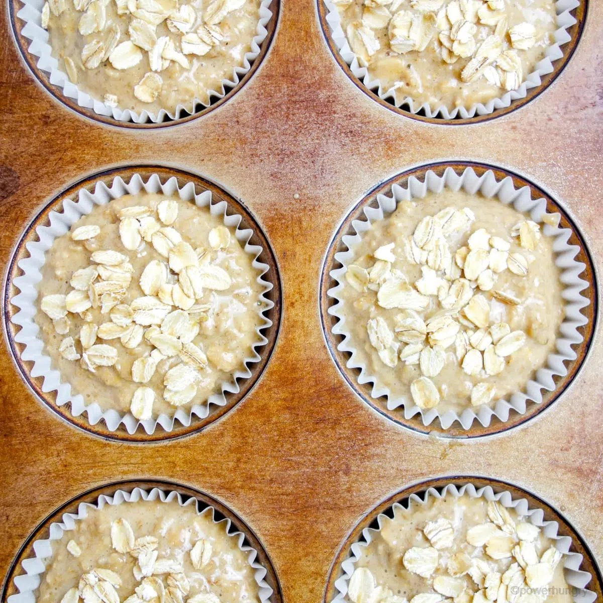 unbaked banana oat muffins in a metal muffin tin