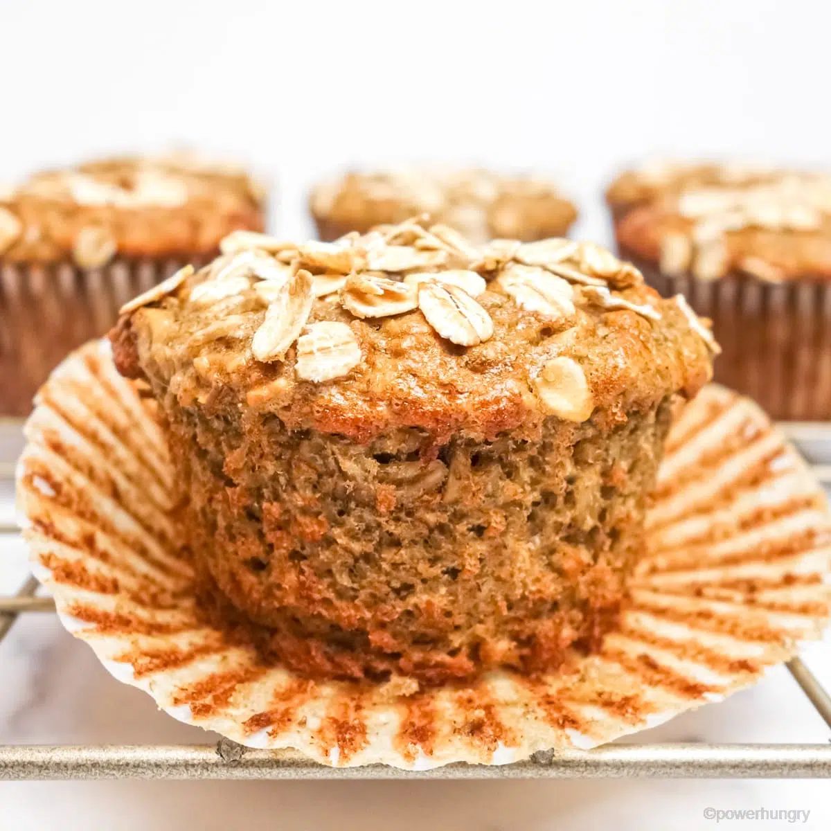 banana oat muffin with the paper removed part way