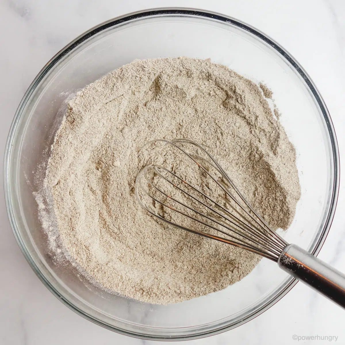 buckwheat flour muffin dry ingredients whisked in a glass bowl
