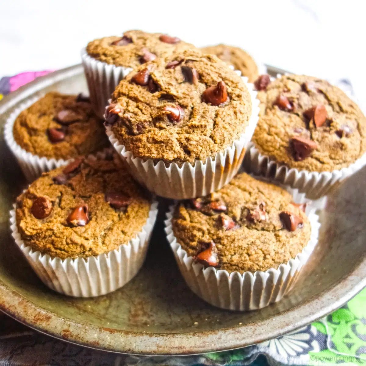 a pile of buckwheat flour muffins in an antique pie tin